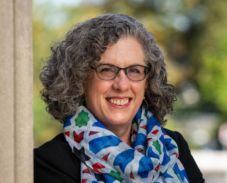 A woman wearing glasses and a colorful scarf